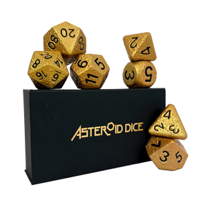 Gold dice set with 'Asteroid Dice' branding on a black stand.