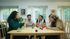 Group playing Asteroid Dice the game around the table